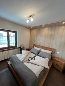a bedroom with a large bed with two glasses on it at Baita PierGi in Livigno