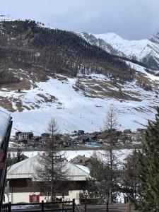 a snowy mountain with a town and a ski slope at Baita PierGi in Livigno