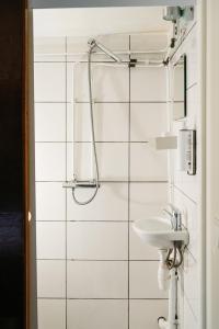 a bathroom with a sink and a shower at Botel Maastricht in Maastricht