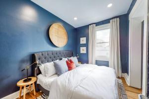 a blue bedroom with a bed and a couch at Luxury Home Close to Nulu Downtown 4th w Kings in Louisville