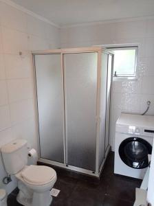 a bathroom with a toilet and a washing machine at Casa Lago Rupanco in Puerto Rico +20 photos