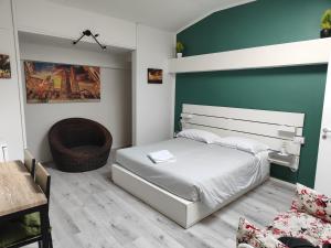 a bedroom with a bed and a table and a chair at Residenza le Torri in Bologna