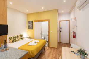 a hotel room with a bed and a bathroom at 731 Costa Cabral Metro Residence in Porto