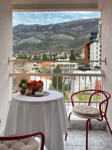 a table and chairs on a balcony with a view at Boka Place - Sutomore in Sutomore