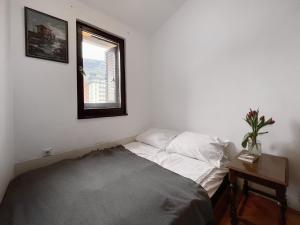 a small bedroom with a bed and a window at Boka Place - Sutomore in Sutomore