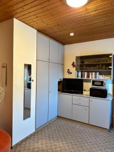a kitchen with white cabinets and a counter top at Fewo Klingelhöfer in Willingen
