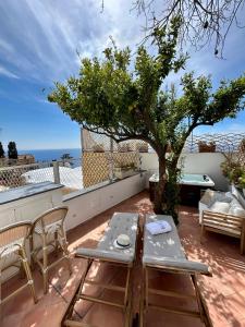 d'une terrasse sur le toit avec une table et des chaises. dans l'établissement Villa Fortuna, à Positano