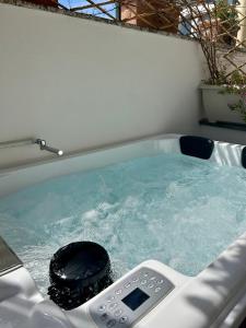 a hot tub with a remote control in it at Villa Fortuna in Positano
