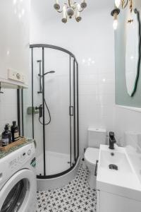 a bathroom with a shower and a washing machine at Heart of Center in Rzeszów +23 photos