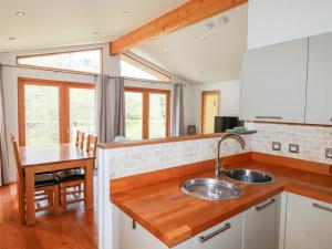 a kitchen with a sink and a wooden counter top at 7 Stonerush Valley in Looe