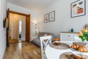 a kitchen and living room with a table and a couch at Heart of Center in Rzeszów