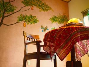 a table and a chair with a blanket on a wall at fumoku - Vacation STAY 12915v in Chino