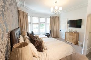 a bedroom with a large bed with a large window at 3 Bedroom villa attached to Host home free parking in Perth