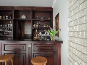 a bar with wooden cabinets and two stools at Altes Tor in Filsen