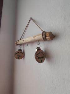 a wooden towel rack with two hanging items on a wall at CASA RURAL FERRETE in Cañete la Real