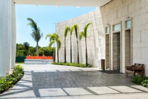 a building with palm trees in front of it at Nickelodeon Hotels & Resorts Punta Cana - Gourmet All Inclusive by Karisma in Punta Cana