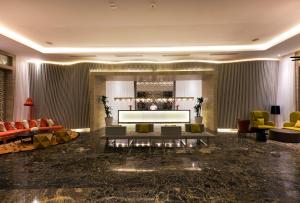 a living room with a couch and a television at Nickelodeon Hotels & Resorts Punta Cana - Gourmet All Inclusive by Karisma in Punta Cana
