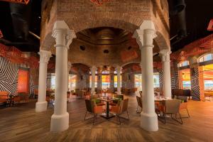 a restaurant with tables and chairs in a building at Nickelodeon Hotels & Resorts Punta Cana - Gourmet All Inclusive by Karisma in Punta Cana