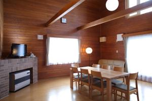 a dining room with a table and chairs and a tv at Esashi-gun - Cottage - Vacation STAY 38366v in Pinneshiri