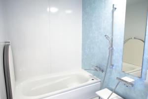 a bathroom with a white tub and a shower at Esashi-gun - Cottage - Vacation STAY 38366v in Pinneshiri
