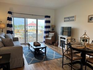 a living room with a couch and a table at Inn at Camachee Harbor View Suite 27 in Saint Augustine