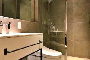 a bathroom with a shower and a toilet and a sink at Shinka Niseko - Vacation STAY 73726v in Niseko