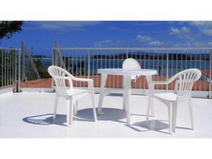 a white table and two chairs on a patio at Amakara okinawa - Vacation STAY 85528v in Yohena +1 photo