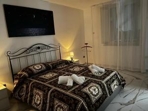 a bedroom with a bed with two pillows on it at Roy Nel cuore di Napoli in Naples