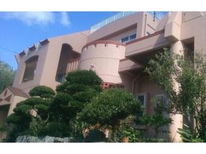 a large building with trees in front of it at Amakara okinawa - Vacation STAY 85516v in Yohena