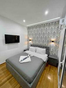 a bedroom with a bed with a tray on it at ATH Luxury Central apartment in Athens