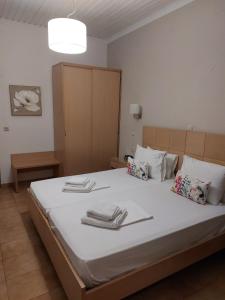 a bedroom with a large bed with towels on it at Daglas Seaside Studios in Nydri