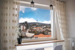 a window with a view of a city at Városi Apartman in Pécs