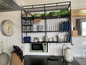 a kitchen with a counter top with a microwave at Pier Cottage, Applecross in Applecross +18 photos