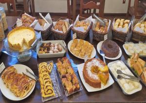 una mesa cubierta con muchos tipos diferentes de postres en Hotel Vila Bavária, en Petrópolis