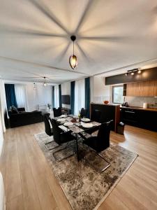a living room with a dining table and a kitchen at Kovacevic Apartments in Kotor