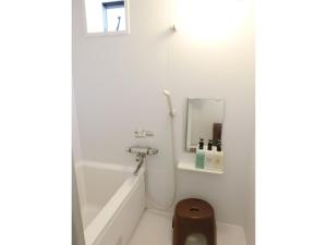 a bathroom with a tub and a sink and a mirror at Plage Yuigahama - Vacation STAY 00225v in Kamakura