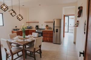 a kitchen with a table with chairs and a refrigerator at Lahos Apartament B in Panajachel
