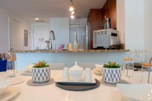 a table with three blue and white vases on it at 314S Nautical Beach Suite - 2 Beds!, Pools, Jacuzzi, Beach, Shops & Dog Friendly in Boynton Beach +42 photos