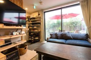 a living room with a couch and a large window at Plage Yuigahama - Vacation STAY 00220v in Kamakura