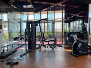 a gym with treadmills and ellipticals in a building at Luxury 1 bedroom apartment in Miraclz tower by Danube Properties in Dubai