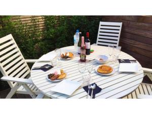 a white table with plates of food and bottles of wine at Plage Yuigahama - Vacation STAY 00222v in Kamakura