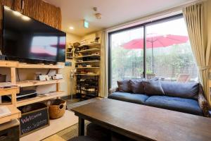 a living room with a couch and a large window at Plage Yuigahama - Vacation STAY 00222v in Kamakura
