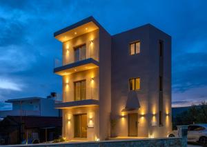 a large white building with lights on it at night at Sans Souci Home in Souda