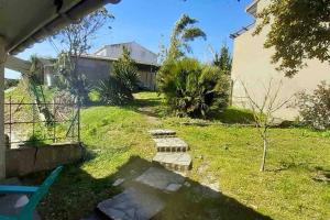 podwórko z ogrodzeniem i domem w obiekcie Maison de vacances 3 chambres avec terrasses w mieście Saint-Georges-de-Didonne