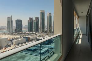 a balcony in a building with a view of a city at 2 Bedrooms in Al Reem Island Near Cleveland Clinic in Abu Dhabi