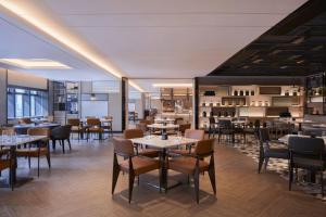 a restaurant with tables and chairs and a bar at Courtyard by Marriott Foshan in Foshan