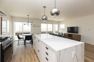 a kitchen with a white counter top and a table at 5609 East Seaside Walk in Long Beach +13 photos