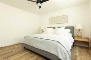 a white bedroom with a large bed with white pillows at 5609 East Seaside Walk in Long Beach