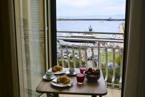 a table with food and a view of a balcony at AM suite Stabiae in Castellammare di Stabia