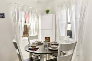 a dining room with a table and chairs and a window at 210 Forty Fourth Street in Newport Beach